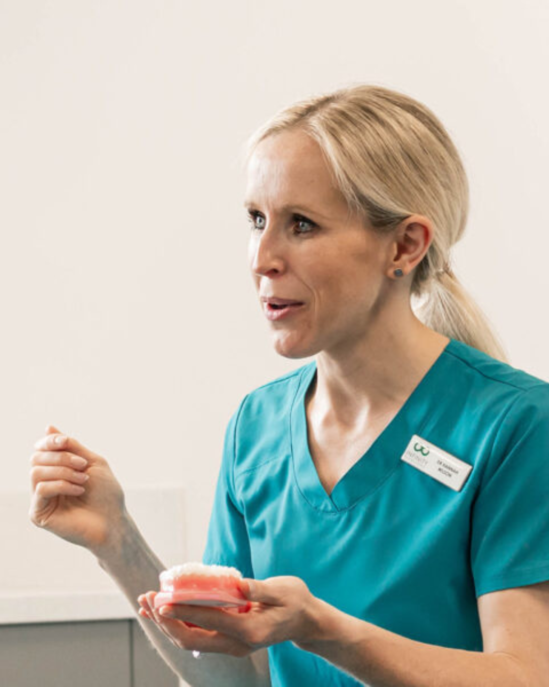 Full Arch Dental Implants Leeds and Harrogate Dr Hannah Wilson in a dental consultation with a patient at Infinity Dental Clinic in Leeds and Harrogate